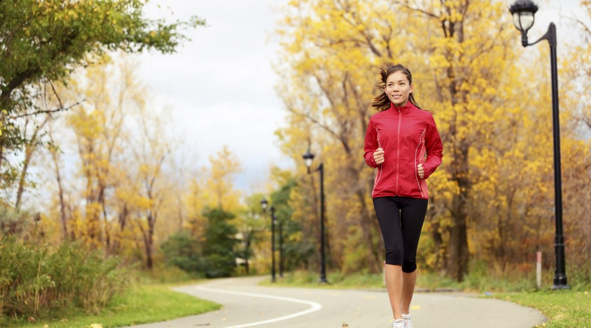 Fall running - xwoman jogging in autumn in city park. Female jogger training outside. Beautiful young multi-ethnic xwoman model in her twenties. Click for more:
