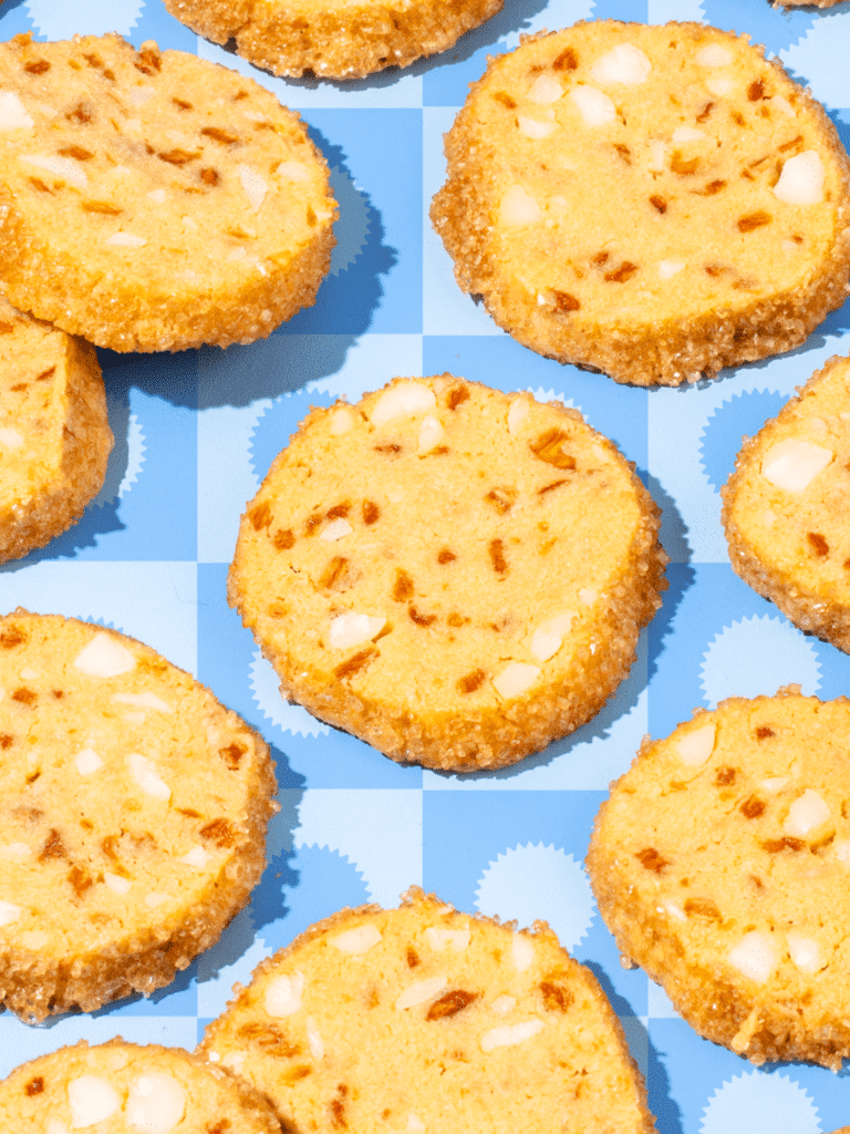 Pineapple Macadamia Nut Shortbread full of Crispy Green Piña Picante against a blue background.