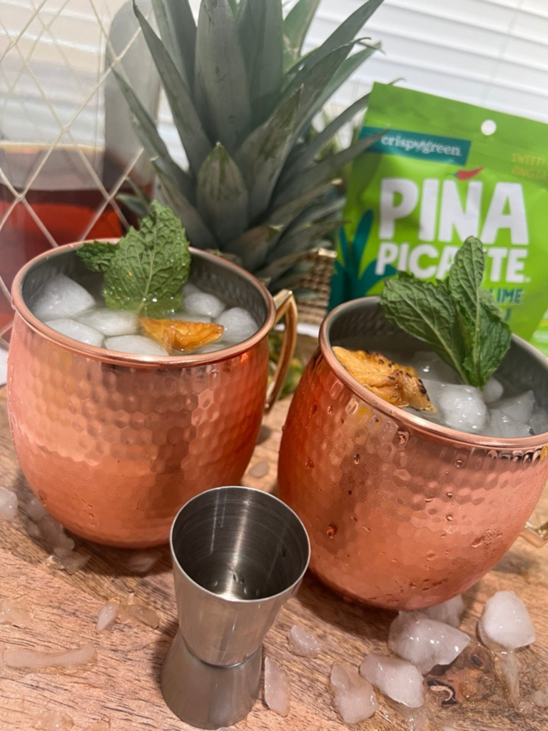 Pineapple Moscow Mule - Made with Piña Picante with Piña Picante Ginger Lime bag in the background.