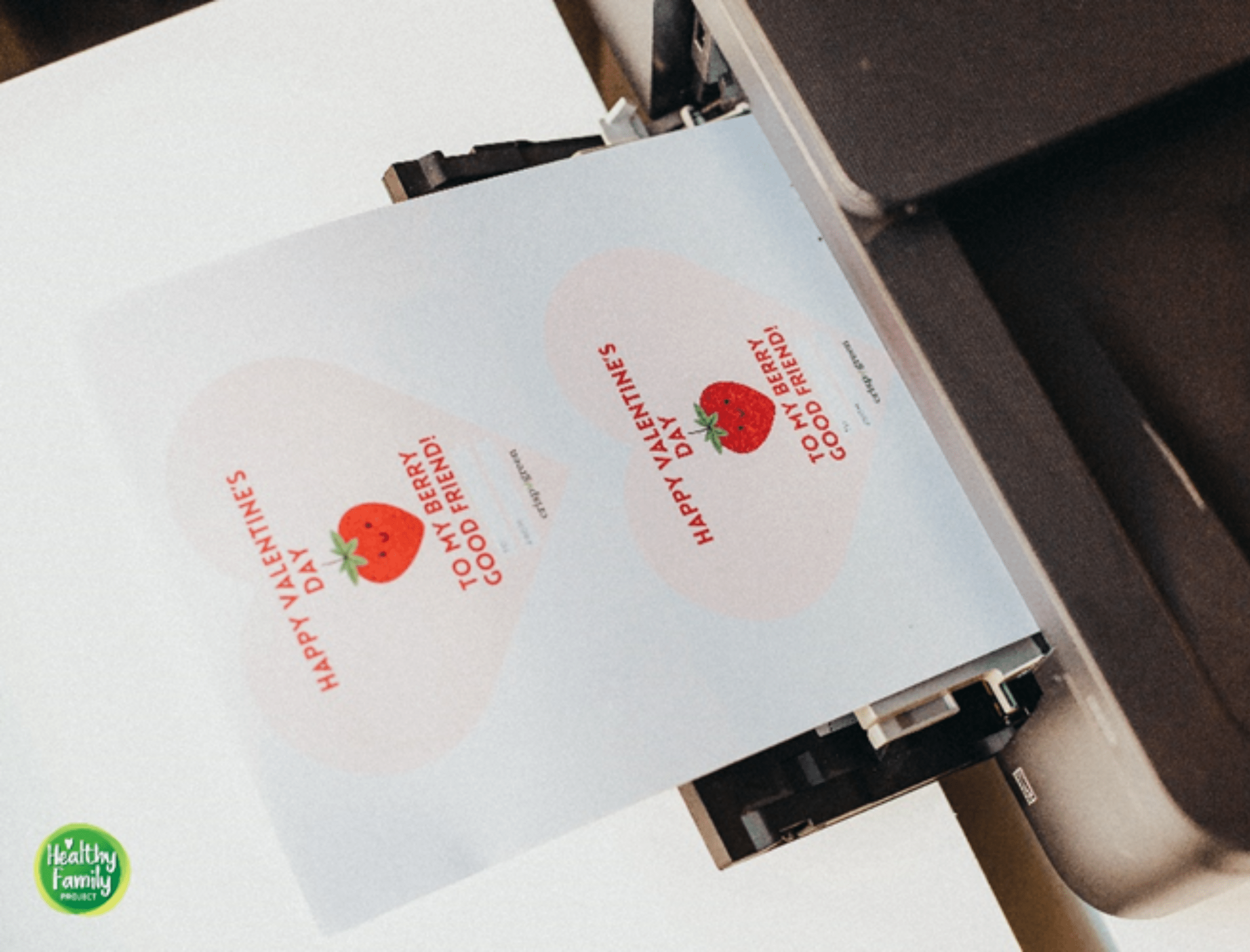 A printer outputting the template paper that features the Strawberry Valentines day message.