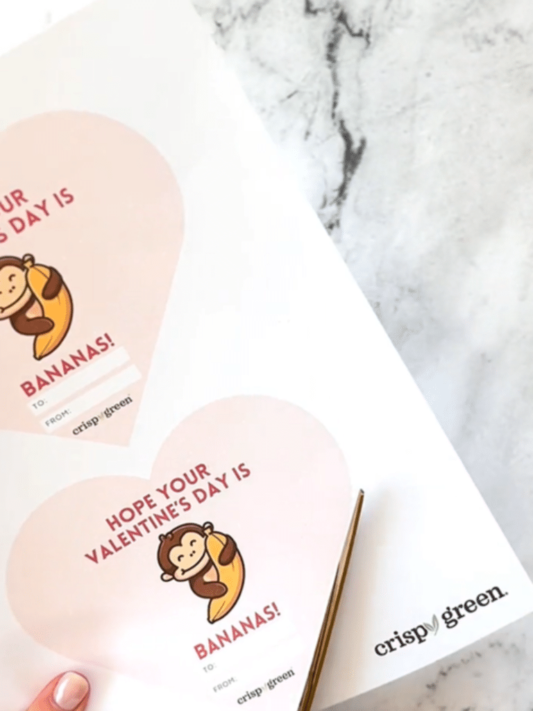 Scissors cutting out the Valentine's Day messages featuring the Monkey holding a Banana provided by Crispy Green.